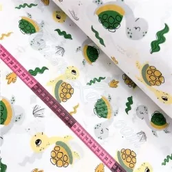 Cotton fabric printed with green seam turtles and plants | Wolf Fabrics